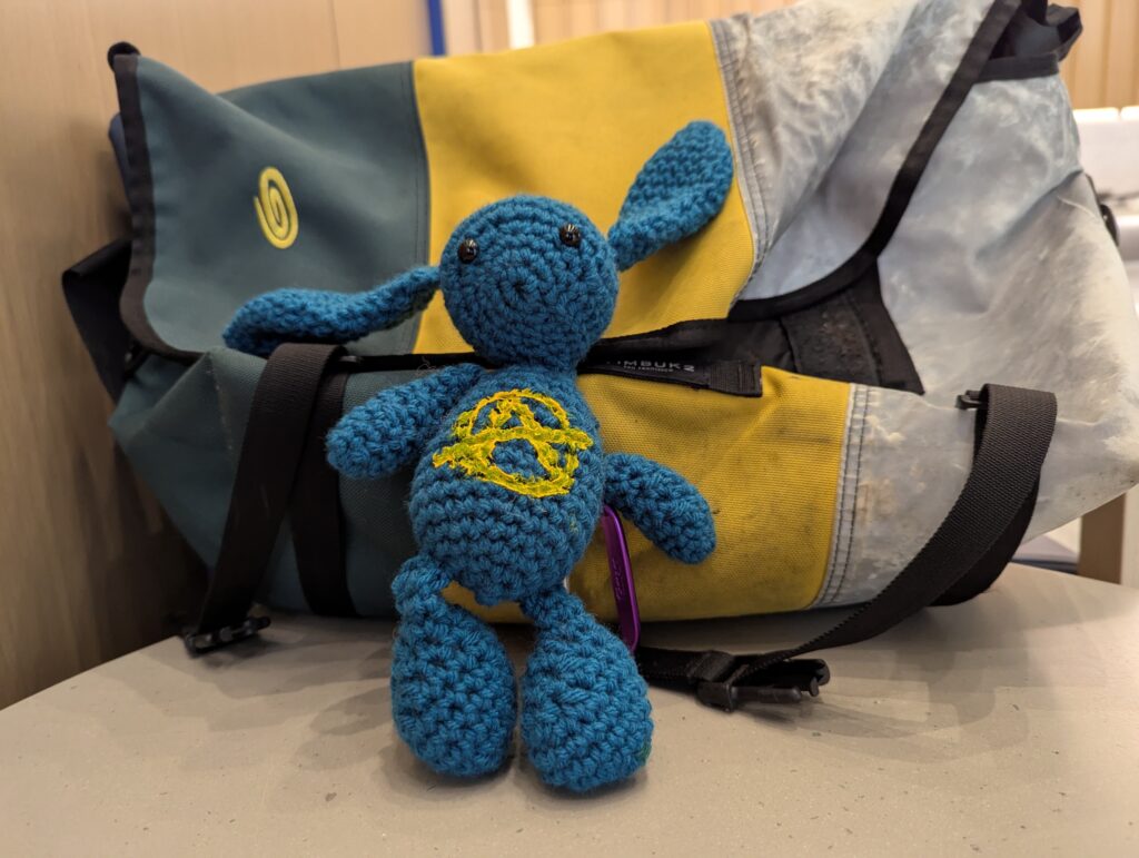 Ana, the anarchist bunny, a knitted stuffed animal